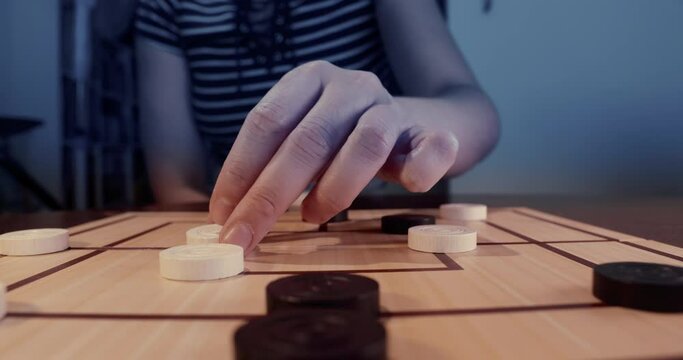 Two People Playing Mills Board Game