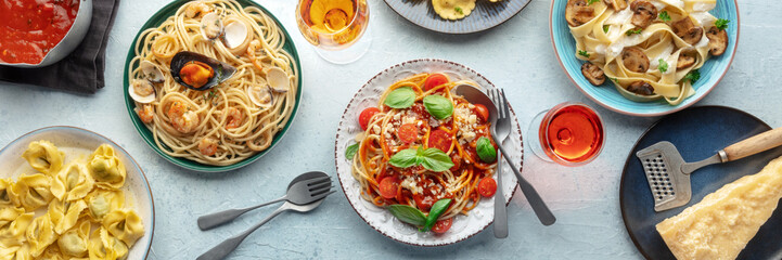 Pasta variety panorama. Italian food and drinks, overhead flat lay shot. Spaghetti marinara, mushroom pappardelle, seafood pasta, wine etc