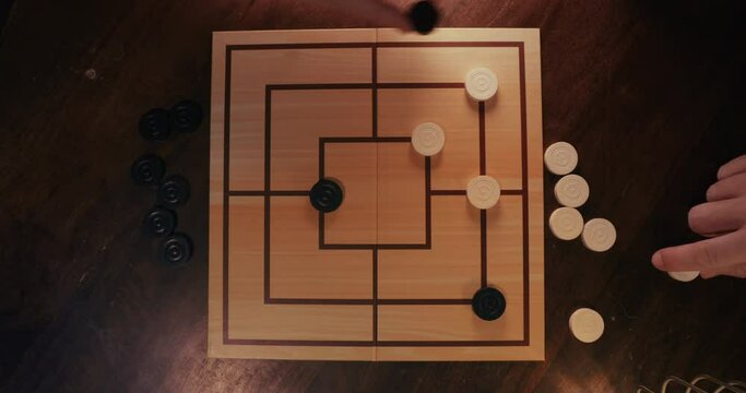 Playing Nine Men's Morris Board Game