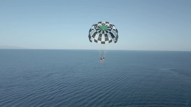 Aerial video of a boat pulling a paraglider in Milos, Greece