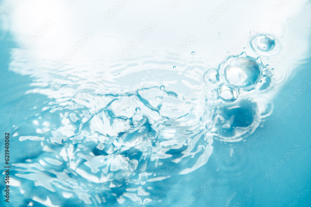 Poster defocus blurred blue color water ripple surface clear calm texture background with splashing bubbles