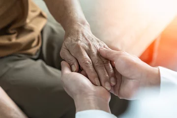 Fotobehang Oude deur Parkinson disease patient, Alzheimer elderly senior, Arthritis person's hand in support of geriatric doctor or nursing caregiver, for disability awareness day, ageing society care service