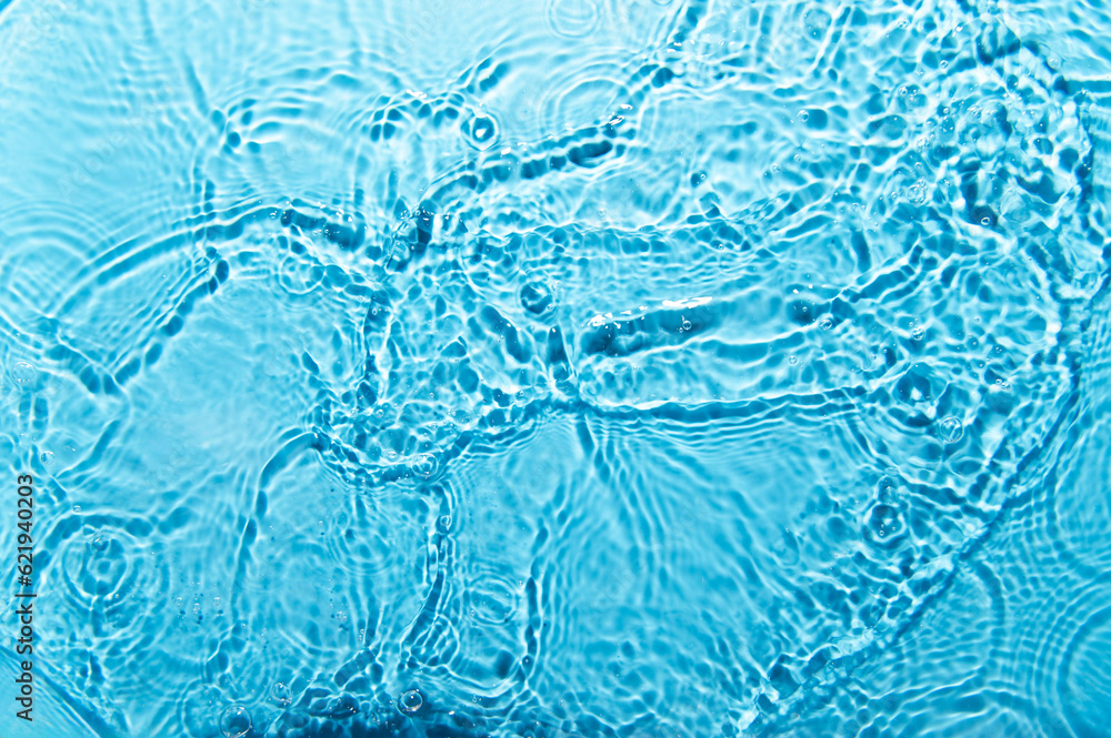 Poster defocus blurred blue color water ripple surface clear calm texture background with splashing bubbles