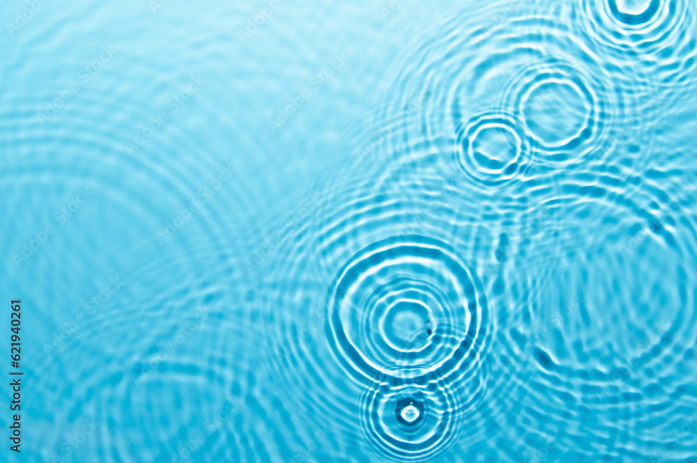 Wall mural defocus blurred blue color water ripple surface clear calm texture background with splashing bubbles