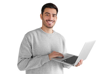 Portrait of young man in gray sweatshirt standing, holding laptop and watching media with happy...