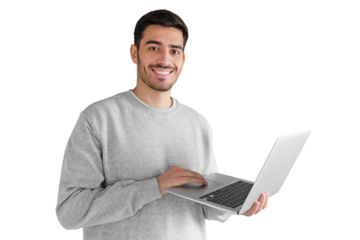 Portrait of young man in gray sweatshirt standing, holding laptop and watching media with happy smile