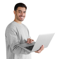 Portrait of young man in gray sweatshirt standing, holding laptop and looking at camera with happy smile