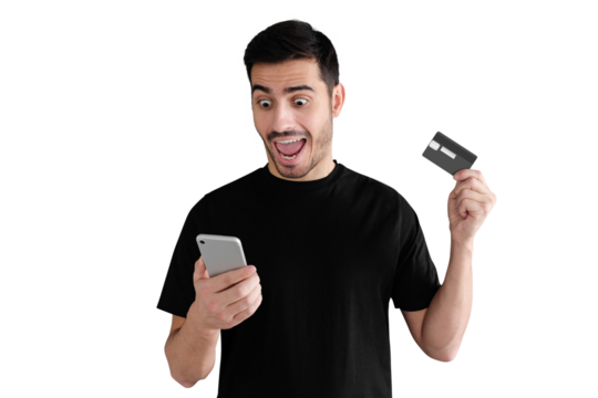 Excited young handsome man standing with mouth open, holding credit card, using mobile phone