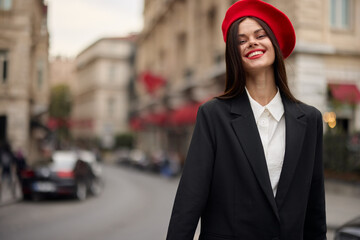 Fashion woman portrait smile teeth standing on the street in the city background in stylish clothes with red lips and red beret, travel, cinematic color, retro vintage style, urban fashion lifestyle.