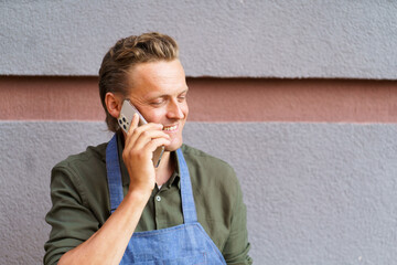 Restaurant worker receive call from client on mobile phone. With focus on communication and...