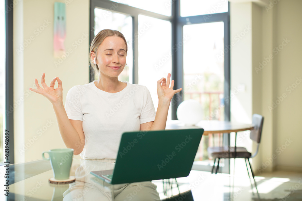 Poster caucasian pretty woman with a laptop looking concentrated and meditating, feeling satisfied and relaxed, thinking or making a choice