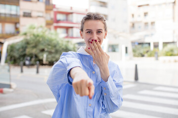 pretty woman laughing at you, pointing to camera and making fun of or mocking you