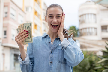 feeling happy and astonished at something unbelievable. dollar banknotes concept