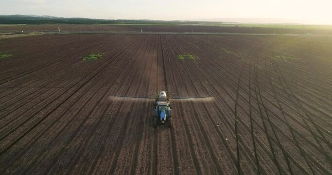 Aerial view of a agricultural machinery at action in a wheat field, Kibbutz Saar, Israel.