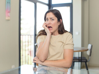 young pretty woman feeling proud, mischievous and arrogant while scheming an evil plan or thinking of a trick