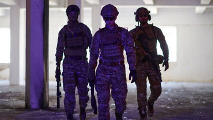 Soldier squad team walking in urban environment colored lightis