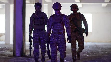 Soldier squad team walking in urban environment colored lightis