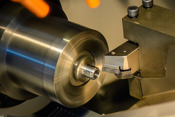 Close up scene the CNC lathe machine thread cutting at the end of metal pipe parts. - obrazy, fototapety, plakaty