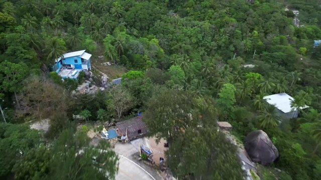 Aerial view of a vehicle driving a forest road on the hill in Tanote bay on the east coast of Thailand.
