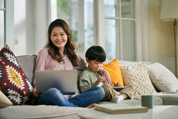 home portrait of young asian mother and five-year-old son