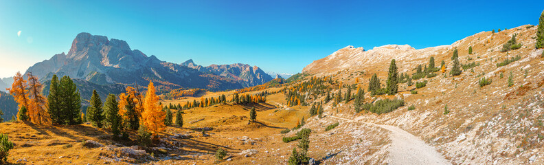 Panorama over magical hiking trail landscape at Mount Specie the national park Three Peaks, Tre Cime Drei Zinnen in Autumn colors at blue sky and sunny day, South Tyrol, Italy