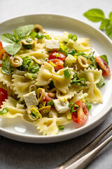 Pasta salad. Traditional Italian pasta with cherry tomatoes, olives, feta cheese, green cabbage.