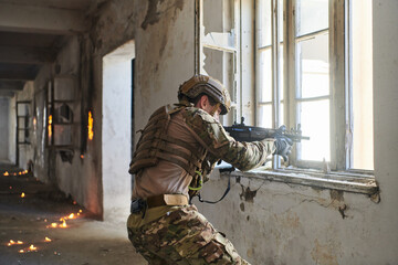 Fototapeta premium A professional soldier carries out a dangerous military mission in an abandoned building