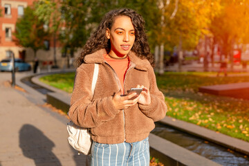 Outdoor portrait of an woman using a mobile phone visiting a Europe city