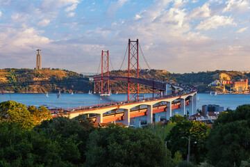View of Lisbon view from Miradouro do Bairro do Alvito tourist viewpoint of Tagus river, traffic on...