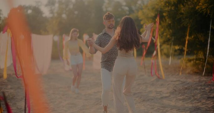 Young couple doing bachata dance at beach