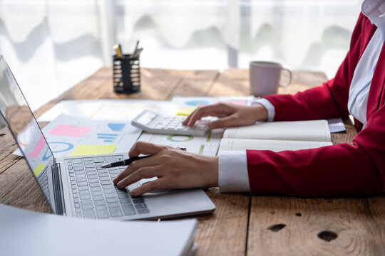 Closed up business woman accountant use computer in office, accountant calculation loan taxes rates law firm of business, bookkeeping ecommerce owner forecast calculation construction project