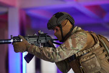 A professional soldier undertakes a perilous mission in an abandoned building illuminated by neon blue and purple lights