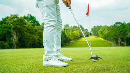 Obraz premium Golf balls that are going to be hole by golfers at the green grass golf course at sunset.