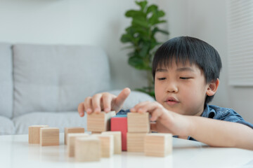 Happy Asian boy playing and learning toy blocks. children are very happy and excited at home. child have a great time playing, activities, development, attention deficit hyperactivity disorder