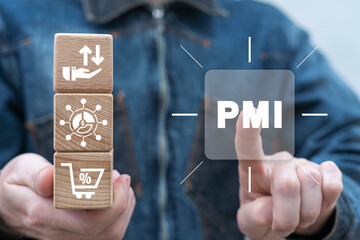 Man holding wooden cubes sees abbreviation: PMI. Concept of PMI - Purchasing Managers Indexes....