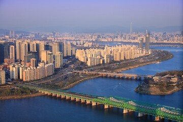 Fototapeta na wymiar Seoul cityscape in South Korea. Aerial view with River Han (Hangang) and Ichon high density residential neighborhood.