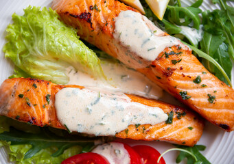Cooked salmon fish fillet with herbs and vegetables