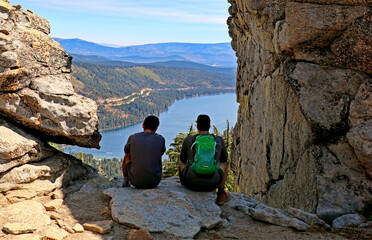 Hikers on the top of California's Donner Peak look down at Donner Lake near Truckee
