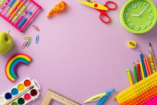 Dive into the excitement of the new school term with this high-angle view of variety of colorful school supplies on a pastel purple background. Personalize empty round frame with text or promotions