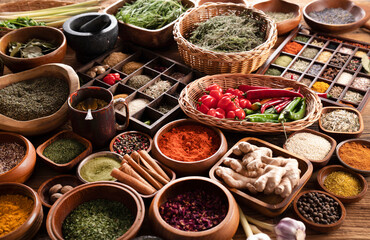 Spices. Collection of spices in bowls on wooden rustic table forming an abstract background.