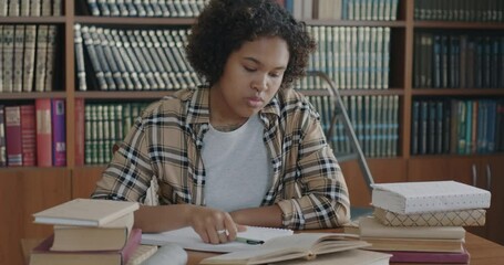 Portrait of stressed female student learning information before exam feeling tired and frustrated. Examination stress and education concept.
