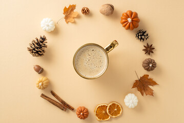Autumnal attributes concept. Above view photo of cinnamon sticks, chinese anise, dried oranges, pinecones, acorns, maple leaves and candles forming a circle for coffee cup on grey isolated background