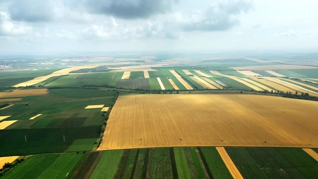 Aerial drone view of nature in Moldova. Wide green fields, partly cloudy sky