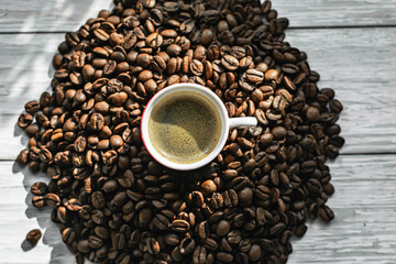 espresso in a red coffee cup. ground coffee. medium roasted coffee beans