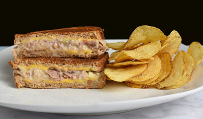 tuna melt sandwich  and  a side  of potato chips,