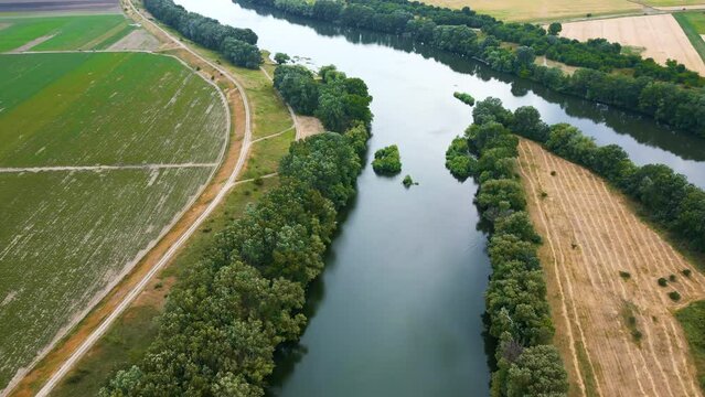 Aerial drone view of nature in Moldova. Dniester river with lush trees along it and fields around
