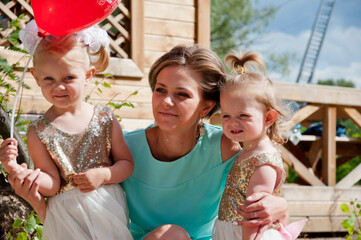 happy mother with two little girls kid outdoor. happy family