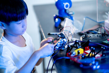 Kid doing science invention experiment on mechanical robots