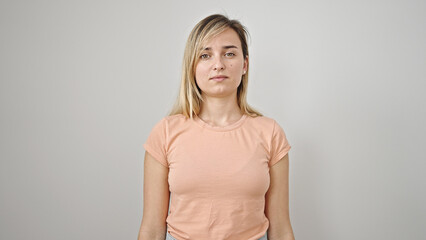 Obraz premium Young blonde woman standing with serious expression over isolated white background