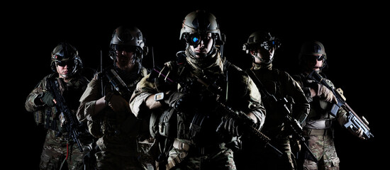 United States Army rangers with assault rifle on dark background